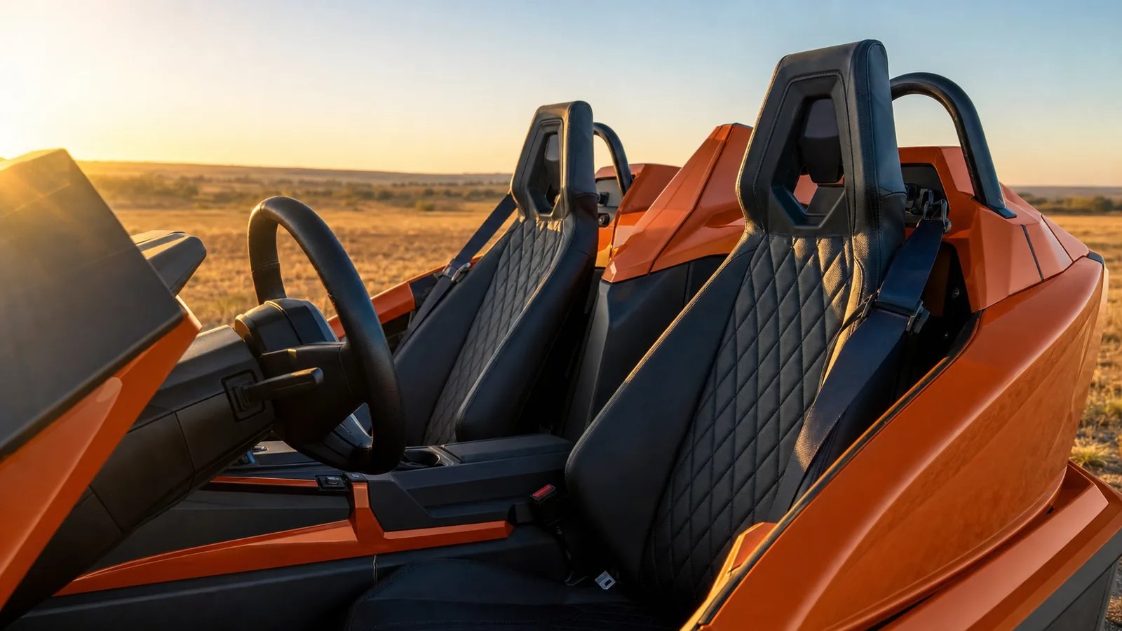 A close detail of the side-by-side bucket seats of an orange Polaris Slingshot at golden hour. Hero image for the Ennis Slingshot article "Polaris Slingshot Weight Limit, Seating and Who Fits"